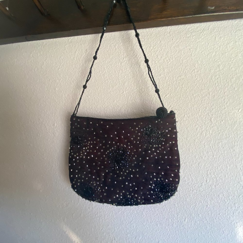 Small formal beaded black clutch with shoulder strap. Designer is Franchi.